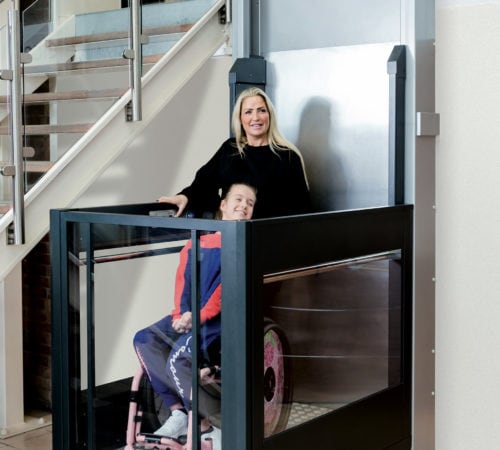 Wheelchair users in Terrys Melody 3 vertical platform lift